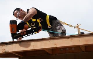 RocStout Roofing and Exterior in Bryan, Texas - a roofer working on a rooftop