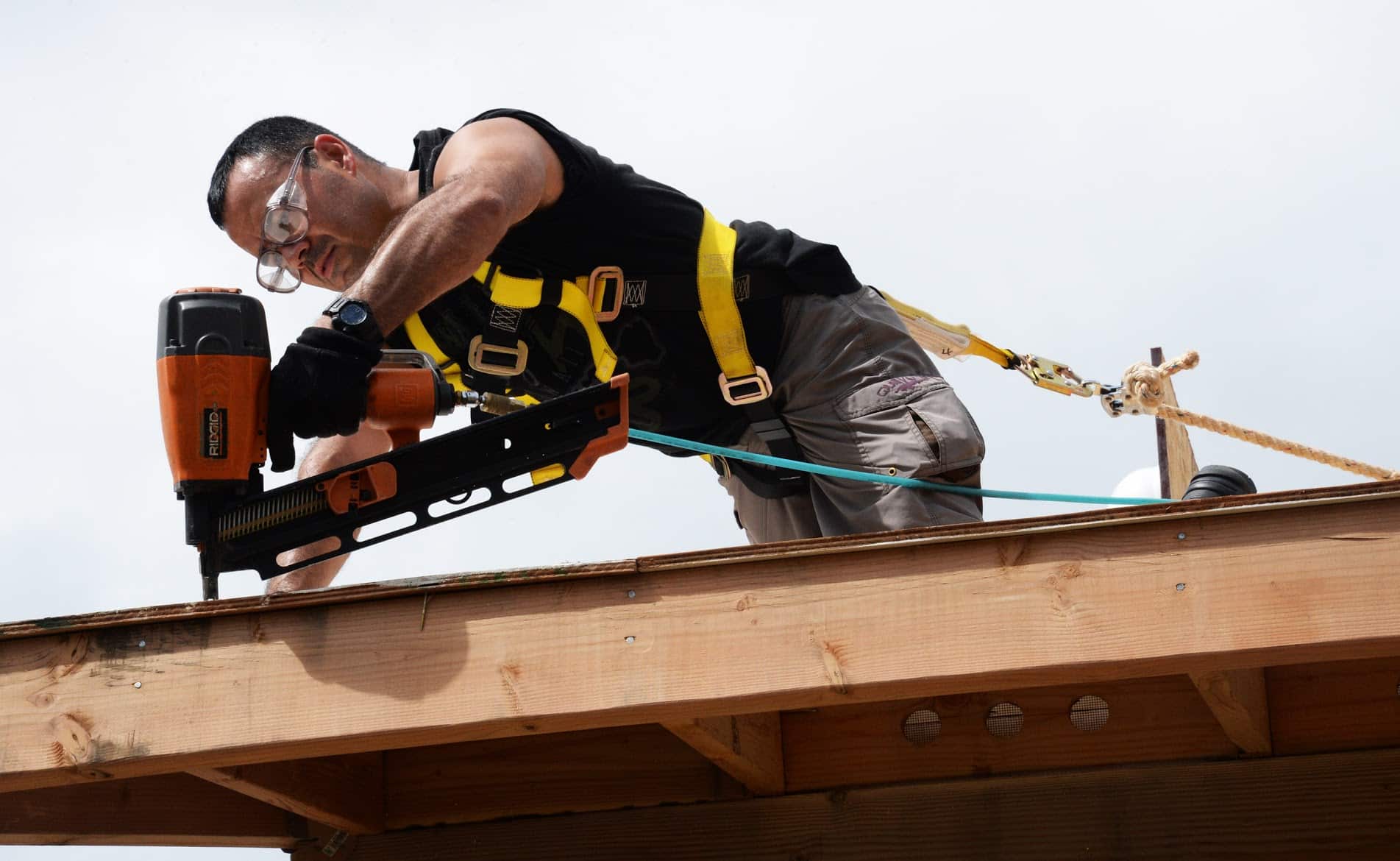 RocStout Roofing and Exterior in Bryan, Texas - a roofer working on a rooftop