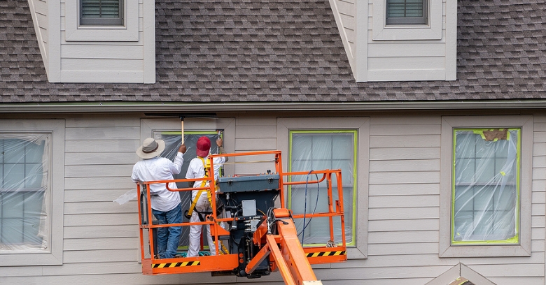 RocStout Roofing and Exteriors in Bryan, TX - roofers painting on a house