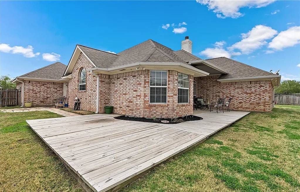 Tiffany Park home with large deck and roof.